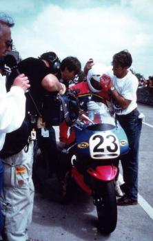 Shaun Harris at the pit  stop with John Britten  and a mechanic